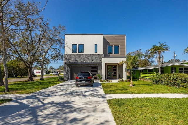 contemporary house with a front lawn, stucco siding, driveway, french doors, and stone siding