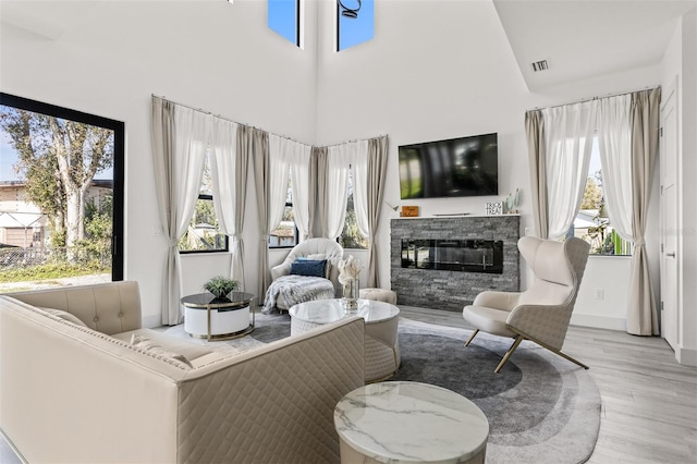 living room featuring light wood-type flooring and plenty of natural light