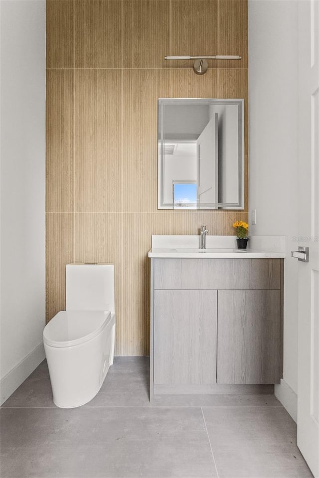 bathroom with vanity, toilet, and concrete flooring