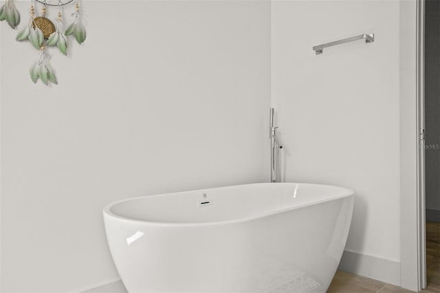 bathroom with a tub and tile patterned floors