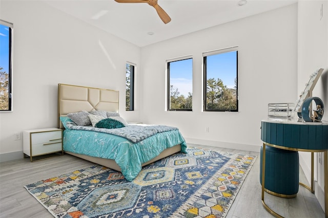 bedroom with ceiling fan and wood-type flooring