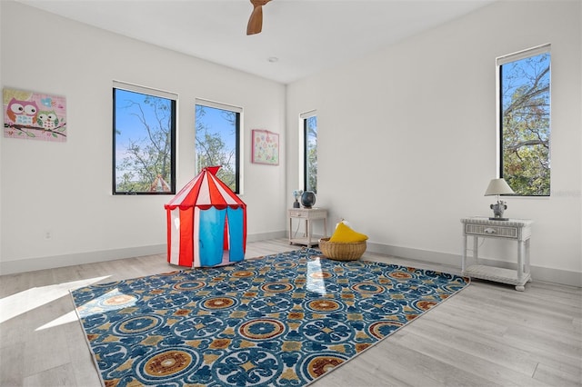 recreation room featuring hardwood / wood-style floors and ceiling fan