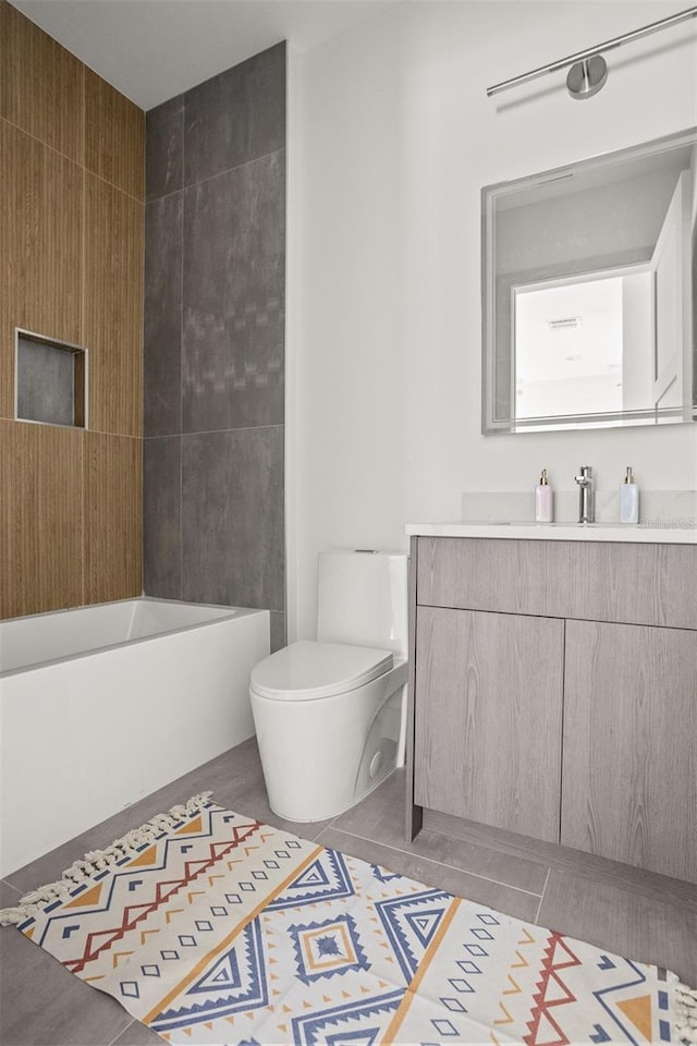 full bathroom featuring toilet, vanity,  shower combination, and tile patterned flooring