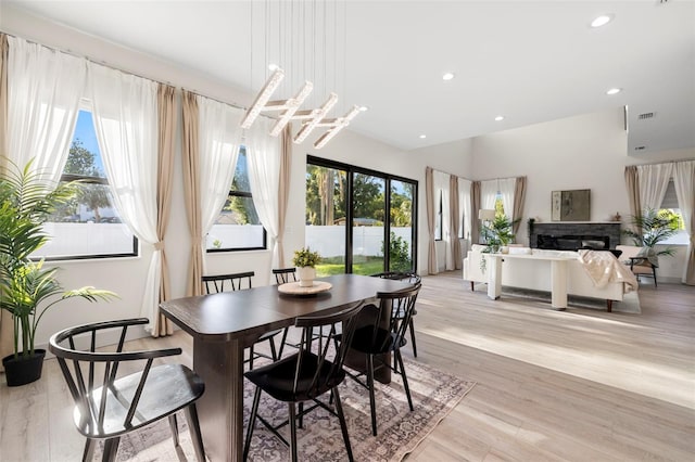 dining area with light wood-style flooring, visible vents, and recessed lighting