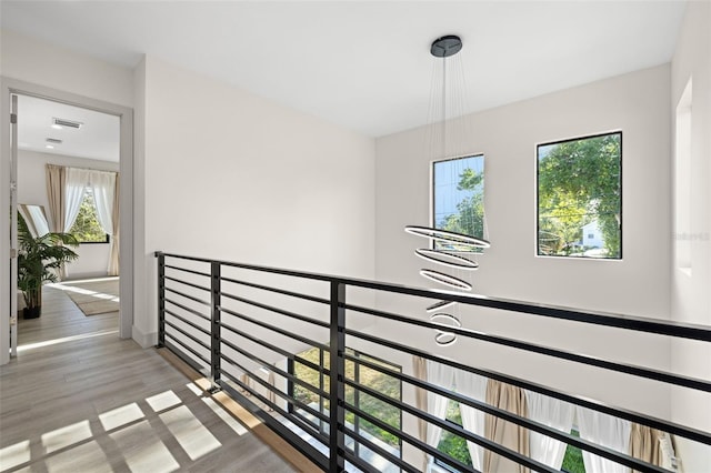 hall featuring visible vents and wood finished floors