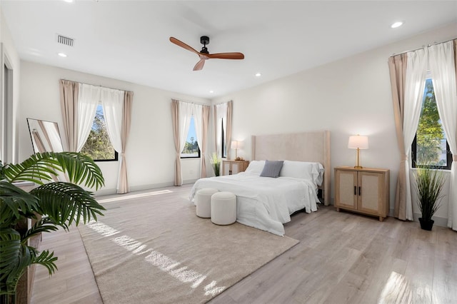 bedroom featuring ceiling fan, visible vents, light wood finished floors, and recessed lighting