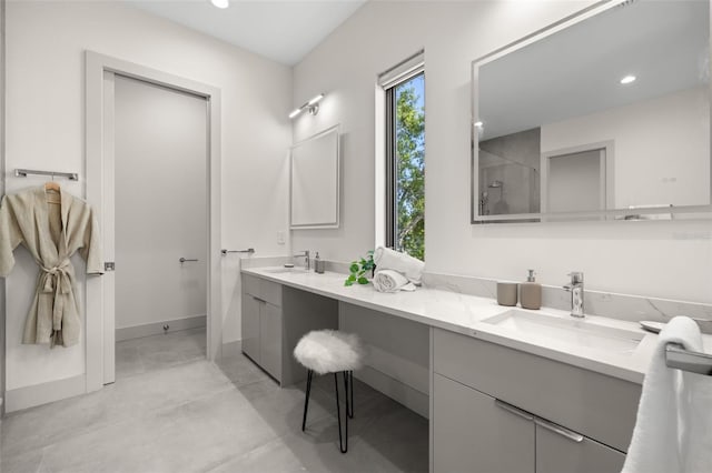 full bathroom featuring baseboards, a sink, a shower, and concrete flooring