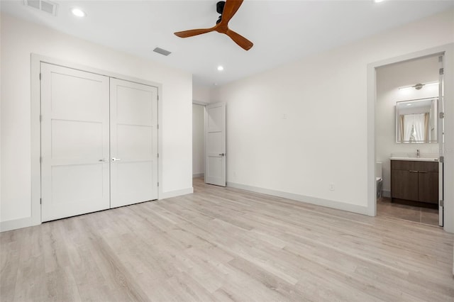 unfurnished bedroom with recessed lighting, ensuite bathroom, visible vents, and light wood-style flooring