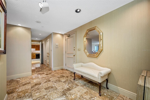 hallway featuring a textured ceiling