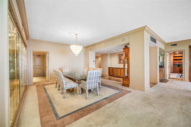 dining space featuring a textured ceiling, crown molding, an inviting chandelier, and light colored carpet