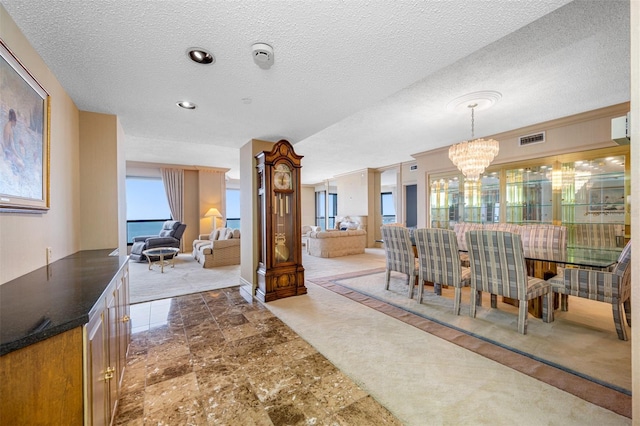 interior space with a textured ceiling and a chandelier