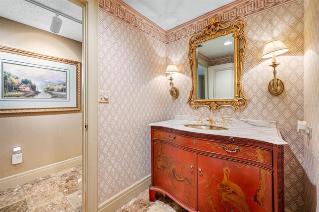 bathroom with a textured ceiling and vanity