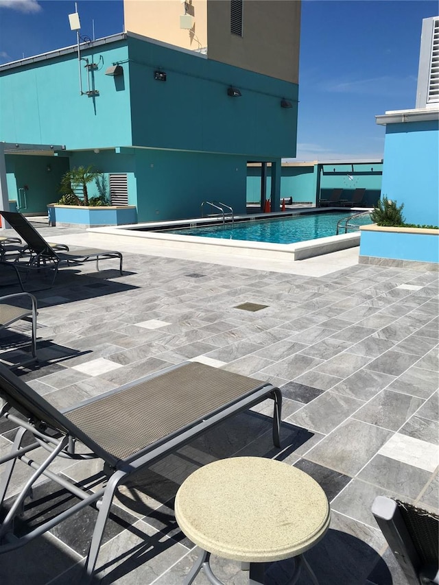 view of swimming pool featuring a patio area