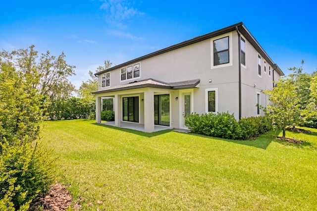 rear view of house with a yard