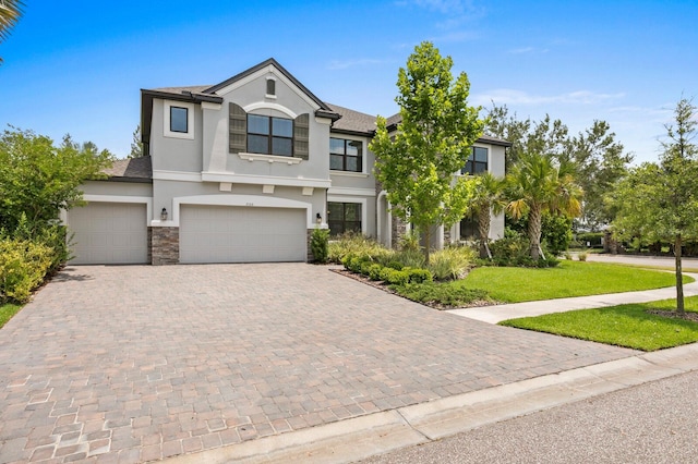 view of front of property with a garage and a front lawn