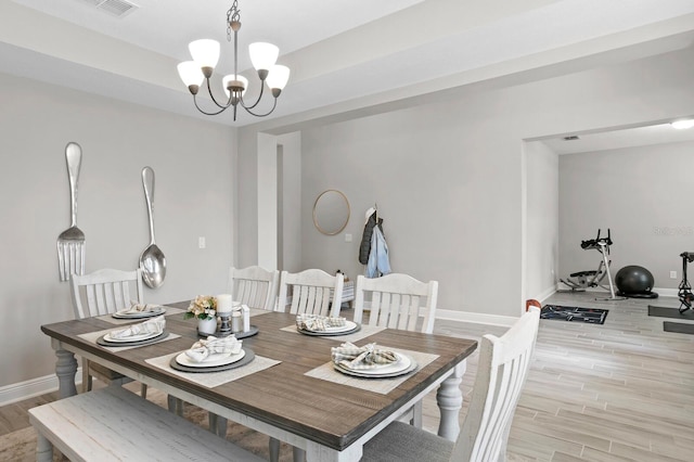 dining area with a notable chandelier and light wood-type flooring