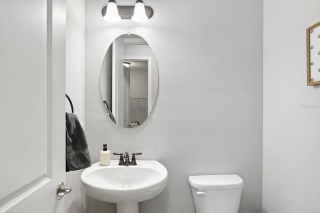 bathroom featuring toilet and sink