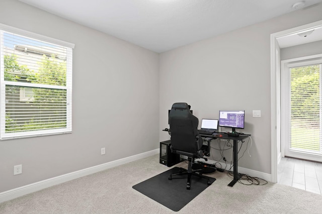 carpeted office space featuring a healthy amount of sunlight