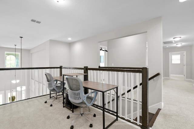 office area featuring carpet floors, plenty of natural light, and a chandelier