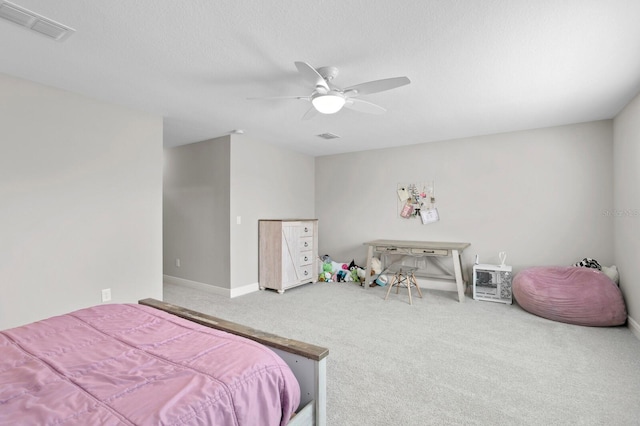 carpeted bedroom with a textured ceiling and ceiling fan