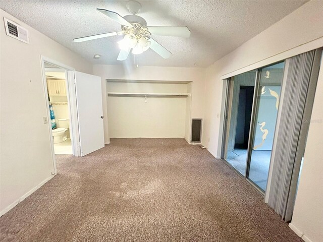 unfurnished bedroom featuring a textured ceiling, carpet flooring, ceiling fan, and a closet