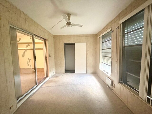 unfurnished bedroom with light carpet, ceiling fan, and a closet