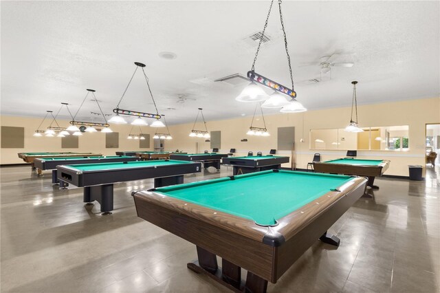 recreation room with a textured ceiling and billiards