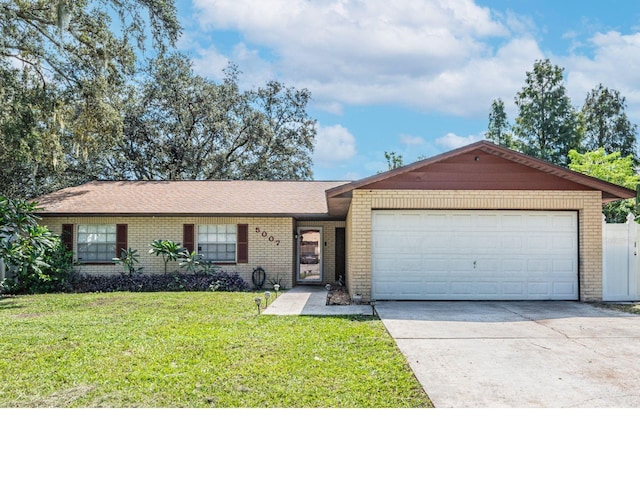 ranch-style home with a garage and a front yard