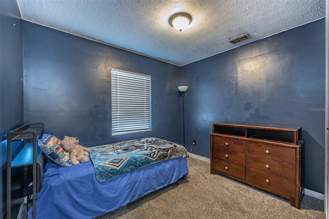 carpeted bedroom featuring a textured ceiling