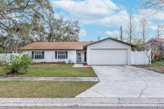 ranch-style home with a garage and a front lawn