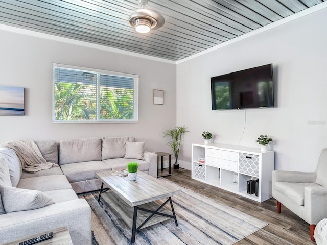 living room with wooden ceiling, wood-type flooring, and ornamental molding