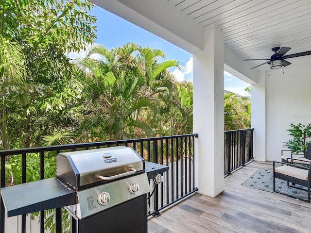 wooden deck with grilling area and ceiling fan