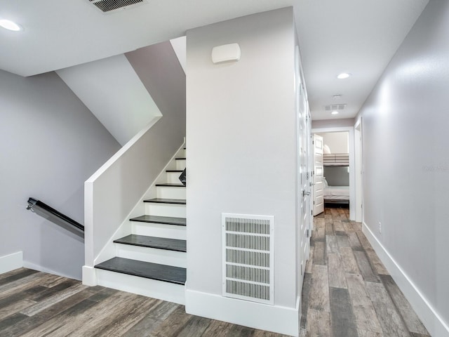 staircase featuring wood-type flooring