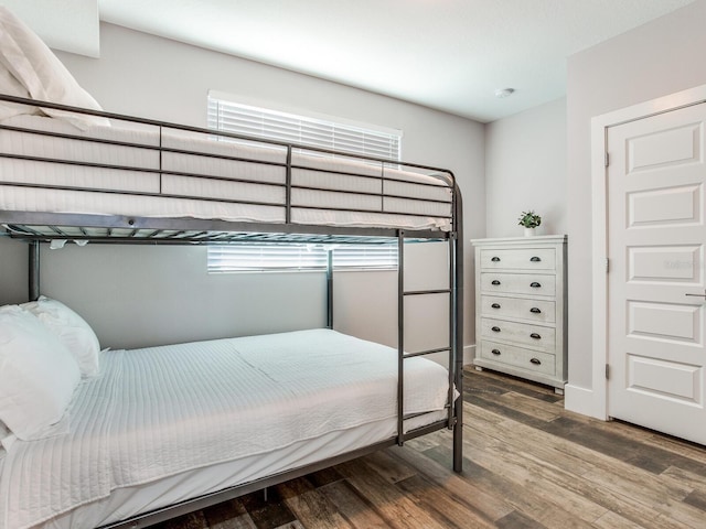 bedroom with hardwood / wood-style floors and multiple windows