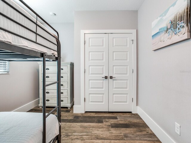 bedroom featuring a closet and dark hardwood / wood-style flooring