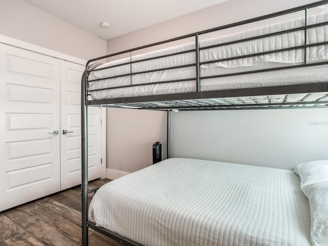 bedroom with a closet and dark hardwood / wood-style floors