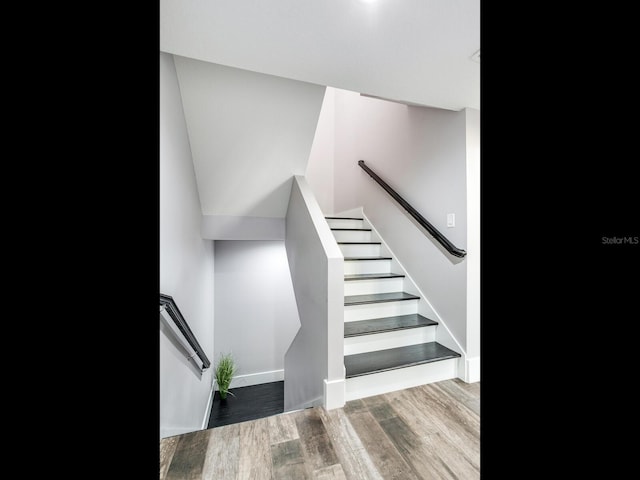 staircase with wood-type flooring