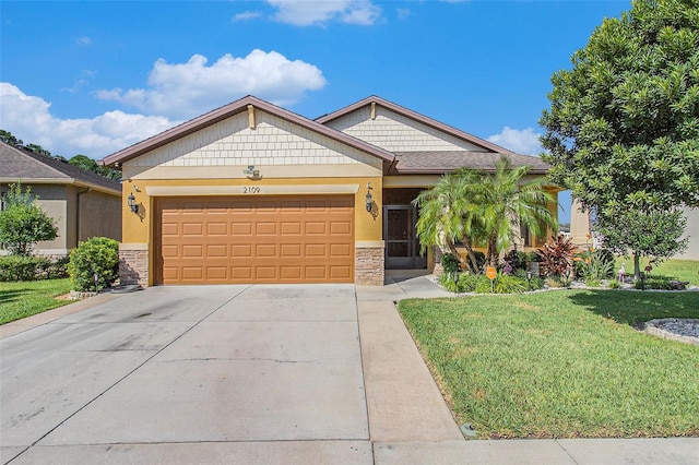 view of front of home with a front lawn and a garage