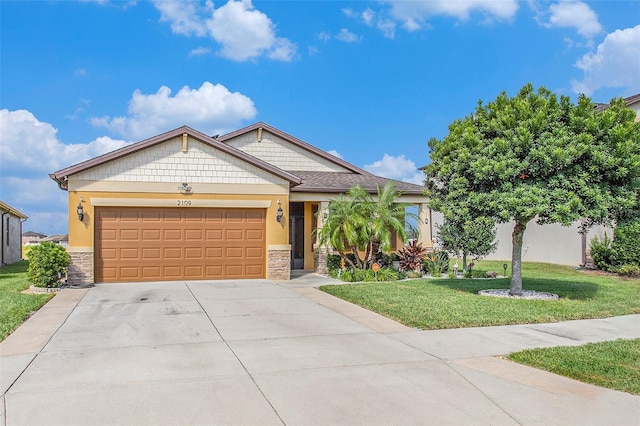 view of front of home featuring a garage and a front lawn