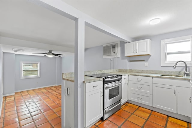 kitchen with light tile patterned flooring, white cabinetry, stainless steel range oven, ceiling fan, and sink