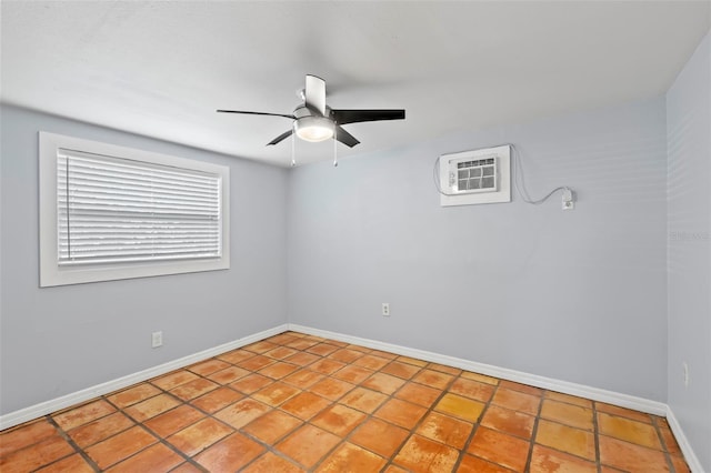 spare room featuring ceiling fan, light tile patterned floors, and a wall mounted air conditioner