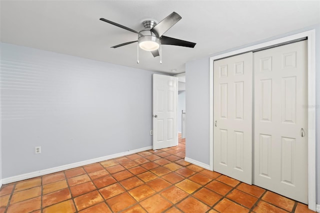 unfurnished bedroom featuring a closet, ceiling fan, and light tile patterned floors