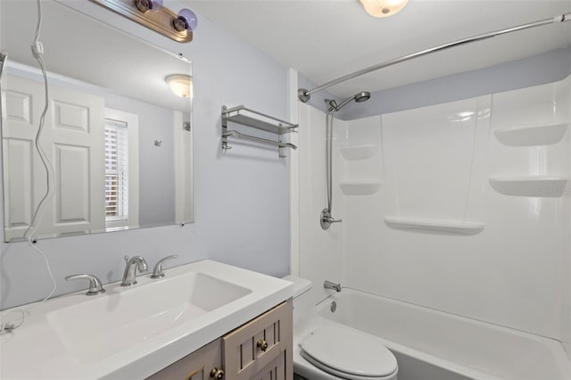 full bathroom featuring vanity, bathing tub / shower combination, and toilet