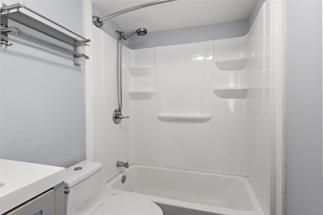 full bathroom featuring washtub / shower combination, vanity, and toilet