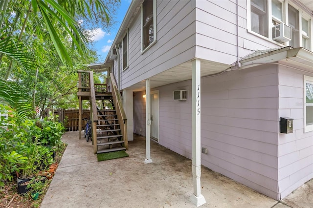 view of property exterior featuring cooling unit, a patio area, and a wall unit AC