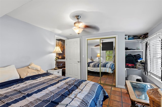 tiled bedroom with a closet and ceiling fan