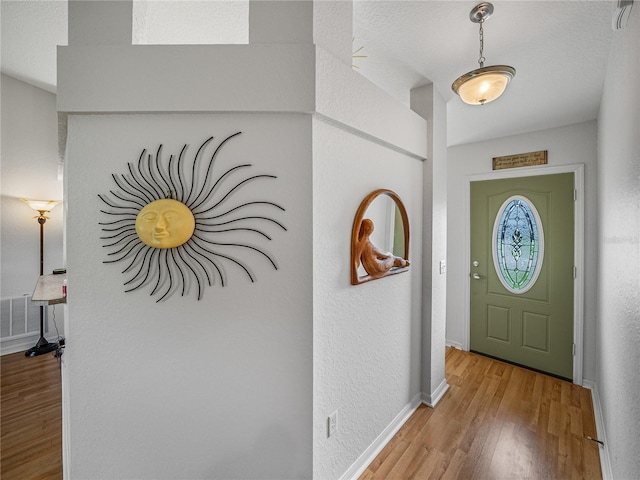 foyer entrance with light hardwood / wood-style floors