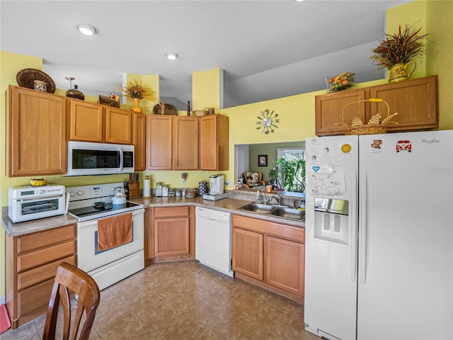 kitchen featuring lofted ceiling, sink, and white appliances