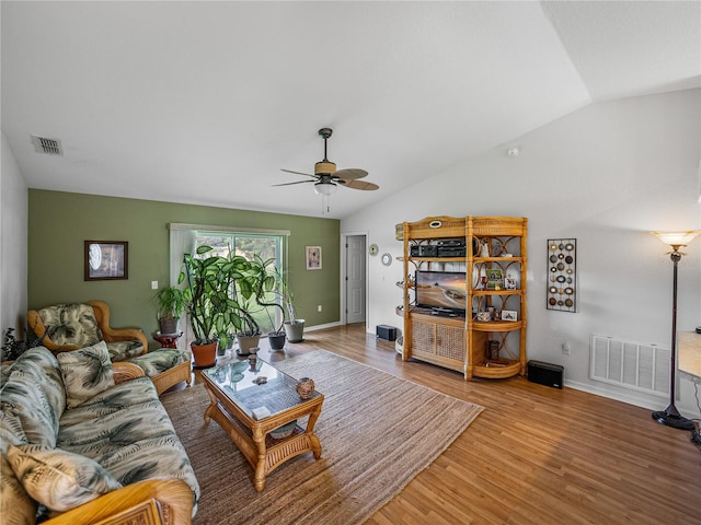 living room featuring wood-type flooring, lofted ceiling, and ceiling fan