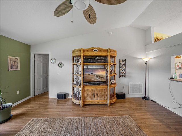 living room with lofted ceiling, ceiling fan, and hardwood / wood-style flooring